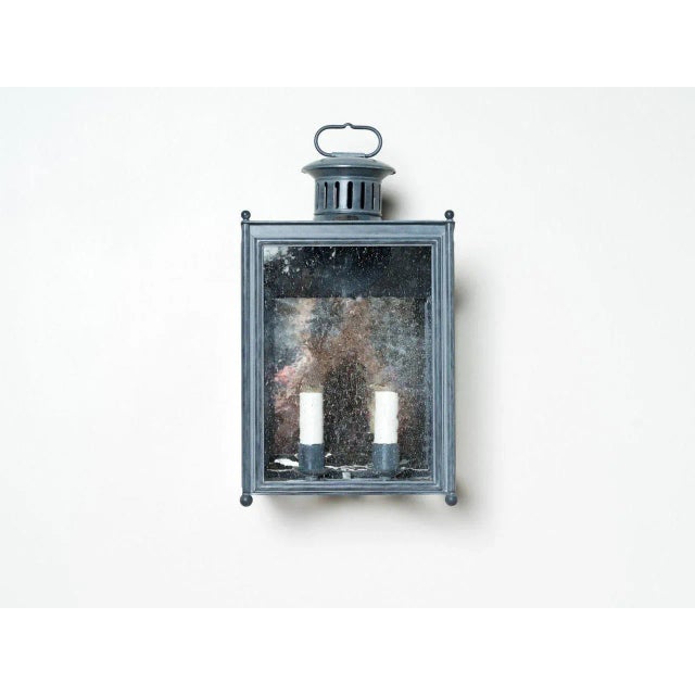 Small metal wall hanging lantern featuring galvanized zinc finish, rippled glass and two candelabra sockets. Socket: 2 -...