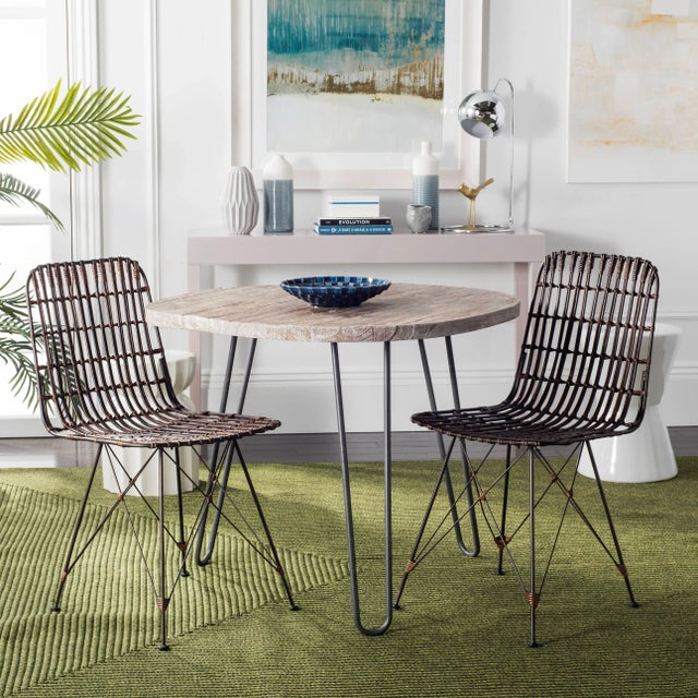 Crafted with fine, graphically sculpted lines, this modern croco brown wicker dining chair was designed to uphold the...