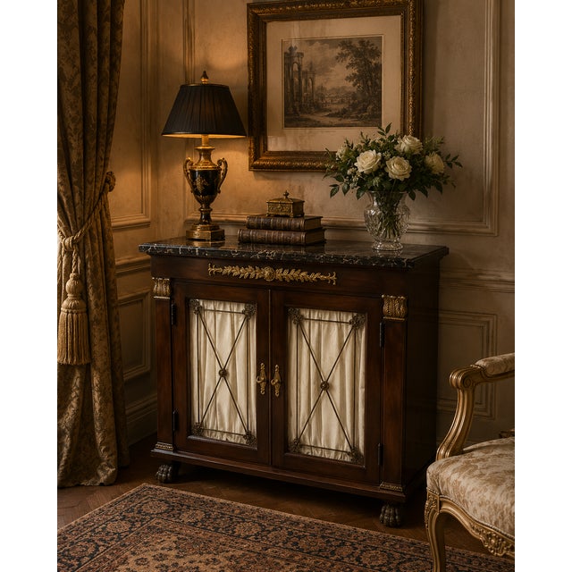 Elegant Henredon cabinet featuring a richly figured mahogany case accented with neoclassical-inspired gilt detailing and a...