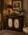 Elegant Henredon cabinet featuring a richly figured mahogany case accented with neoclassical-inspired gilt detailing and a...