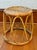 A vintage bentwood rattan stand with a woven top and graceful looped legs. Please see condition details noted. Most items...