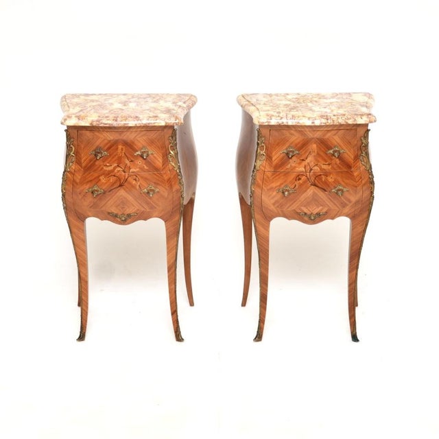 A stunning pair of antique French inlaid marble top bedside chests. They were made in France and date from around the...