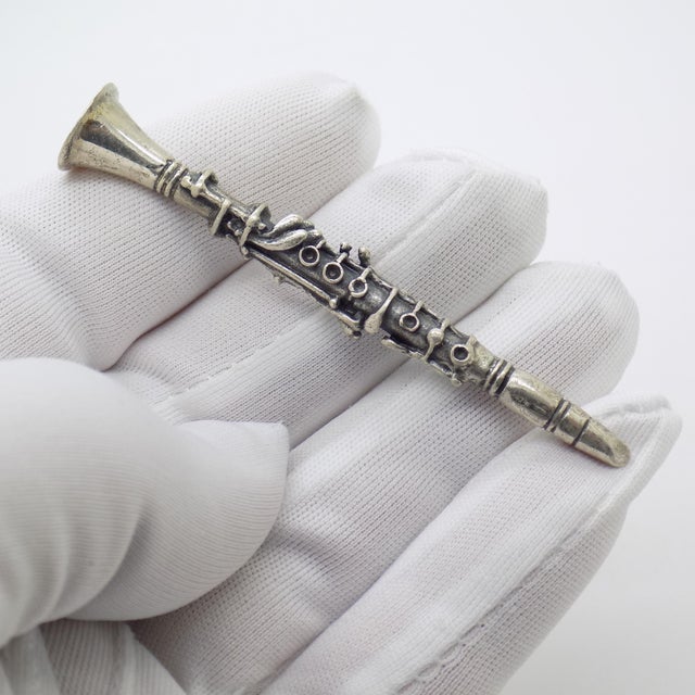 A refined tribute to classical music, this vintage Italian miniature represents a clarinet rendered in solid sterling...