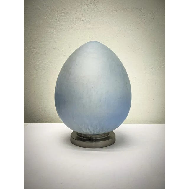 Large egg-shaped table lamp made of hand-blown ice-blue glass with white ‘clouds’, Italy 1980s. Heavy-quality thick glass....