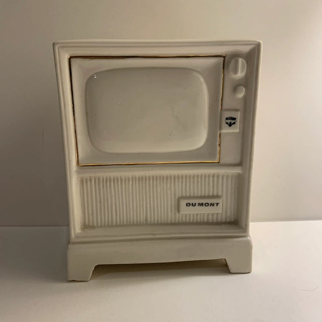 Very scarce Dumont TV savings bank. Cream colored ceramic with slit in top. Missing plug in bottom. Great birth of...