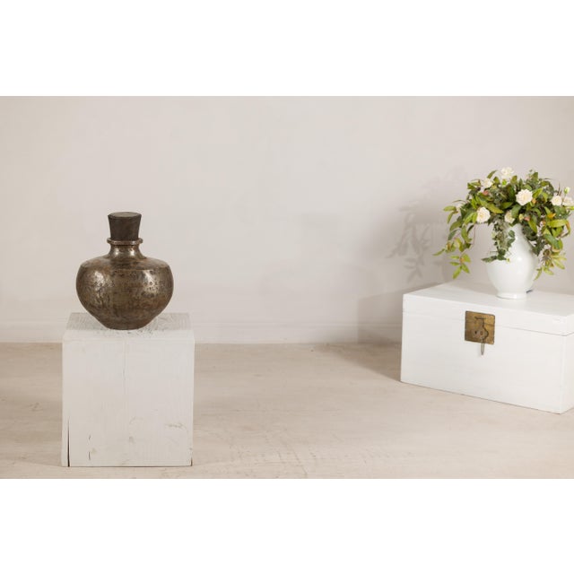 This vintage Indian metal water vessel features a generous circular body rising to a narrow neck with a broad collar and...
