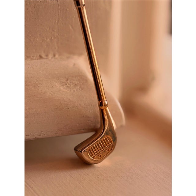 A charming piece for design lovers and collectors of vintage stationery. This gold-colored metal letter opener features a...