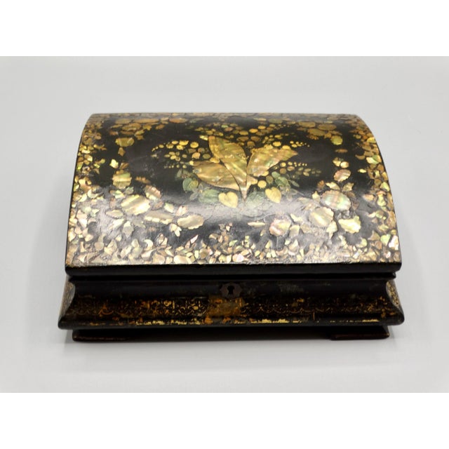 19th-Century Chinese Export ebonized papier mache box inlaid with lovely gold mother of pearl and hand painted gilt. It is...
