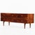 A handsome mid-century walnut dresser distinguished by its richly figured and bookmatched veneered drawer fronts that...