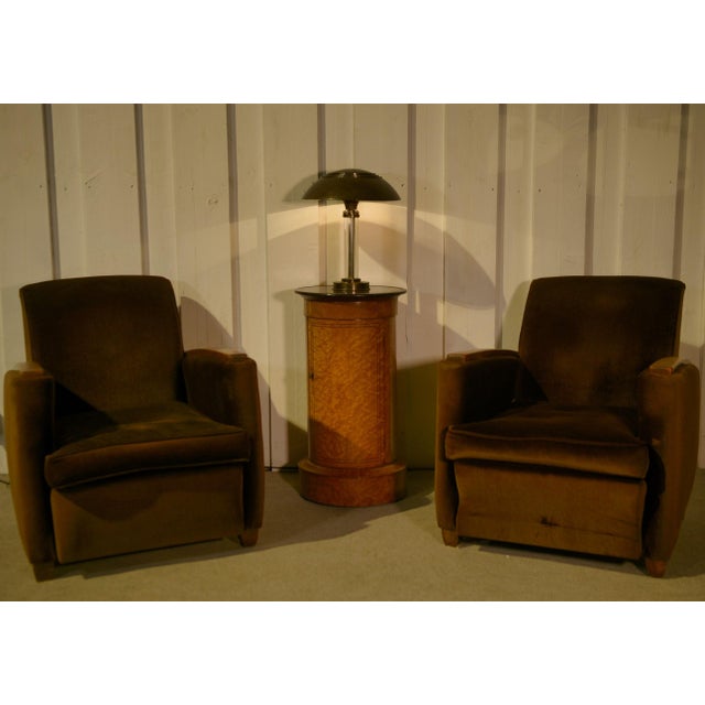 A 1940s Art Deco table lamp in patinated metal with a large mushroom-shaped shade. The central stem is composed of glass...