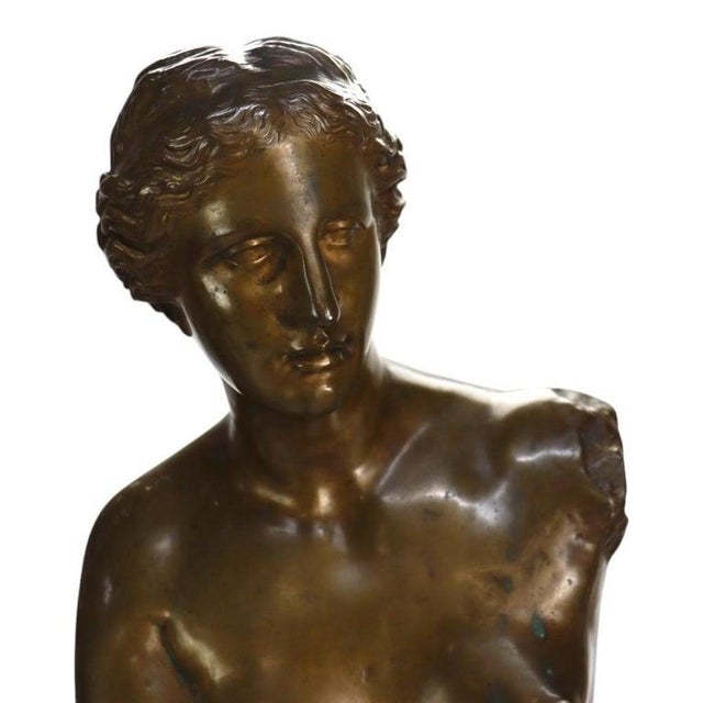This monumental antique bronze sculpture depicts the iconic 'Venus De Milo' , a classical figure celebrated for its...