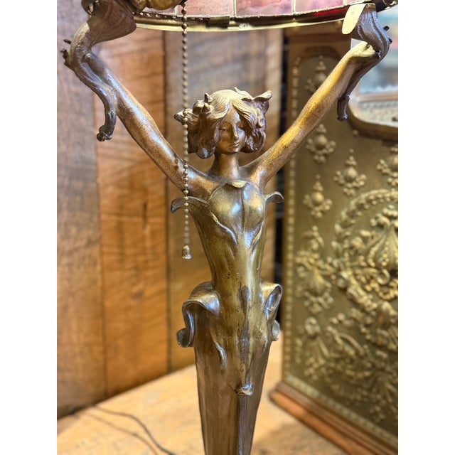 Striking Art Nouveau figural table lamp in cast bronze, signed J. Causse, dating to circa 1900. The sculptural base...