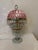 This lamp features a cranberry-pink colored glass domed shade paired with brass-toned hardware and multiple (4) tiers of...