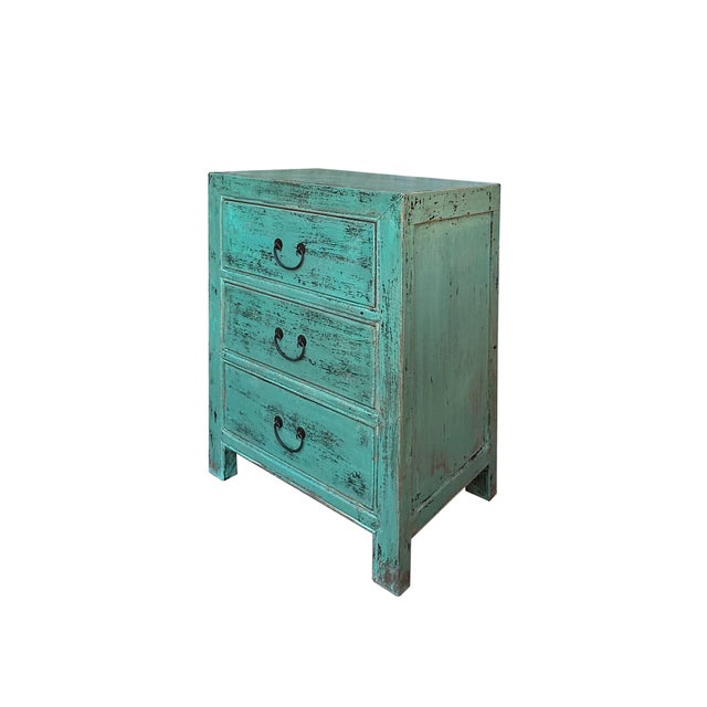 This rustic nightstand embodies a timeless, weathered charm with its distressed, teal green finish that reveals hints of...
