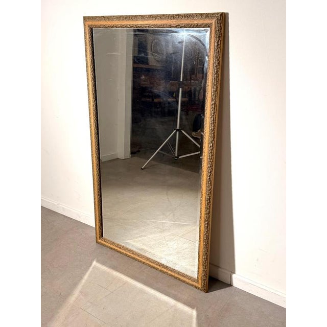Striking rectangular wall mirror featuring a natural wood frame with decorative bark detailing . The combination of warm-...