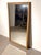 Striking rectangular wall mirror featuring a natural wood frame with decorative bark detailing . The combination of warm-...