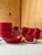A rare, complete combi-service in saturated crimson red by Potterie De Driehoek, Huizen (Netherlands), 1960s. Set includes...