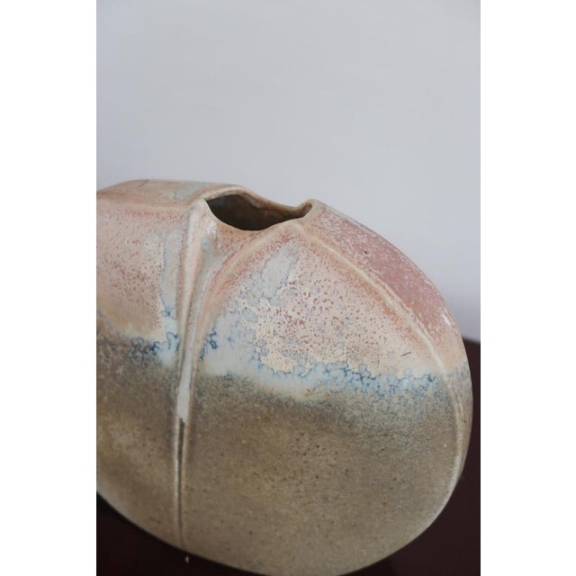 A pebble-form vase in porcelain by virebent, the toulouse manufactory, made in france in the 1970s. The flattened body is...