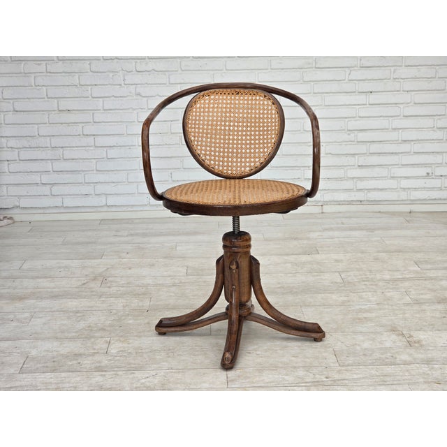 1950s, adjustable swivel armchair in Thonet style. Beech bent wood, furniture mesh, cast iron seat mouting. Original good...