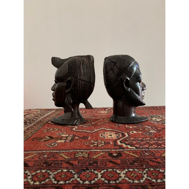 A handsome pair of vintage carved African heads. Each of these beautifully male and female heads are hand carved and...