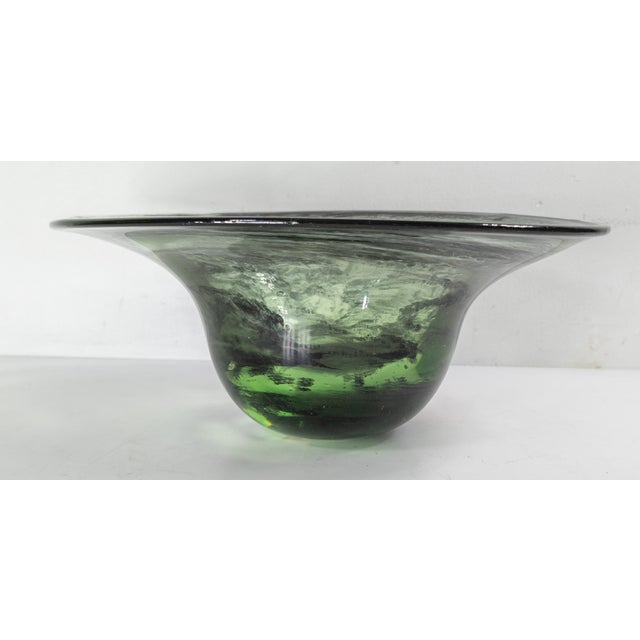 We are selling this simple Mid-Century Art Glass bowl. This bowl has free form design and is hand blown from a translucent...