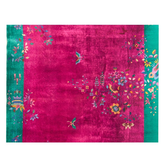 A beautiful early 20th century Chinese Art Deco rug with a bold fuchsia ground overlaid with myriad auspicious peonies and...