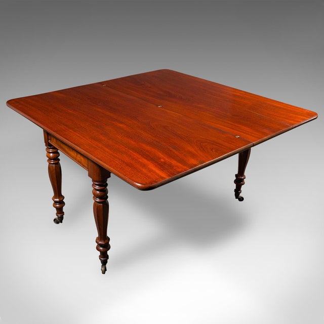 This is an antique metamorphic console table. An English, mahogany fold-over 4 seat dining or bridge table, dating to the...