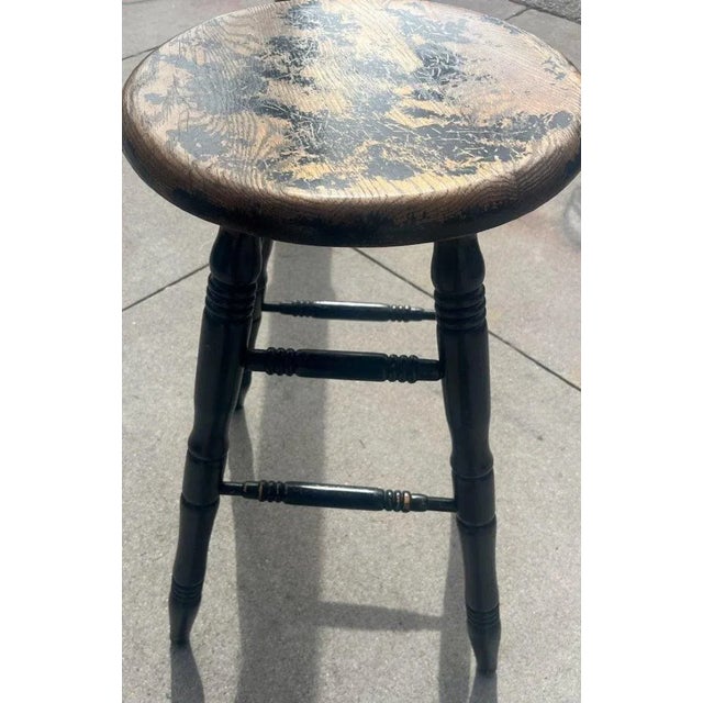 This fine splay leg original black painted industrial stool swivels and rotates all the way around. It is heavy and solid...