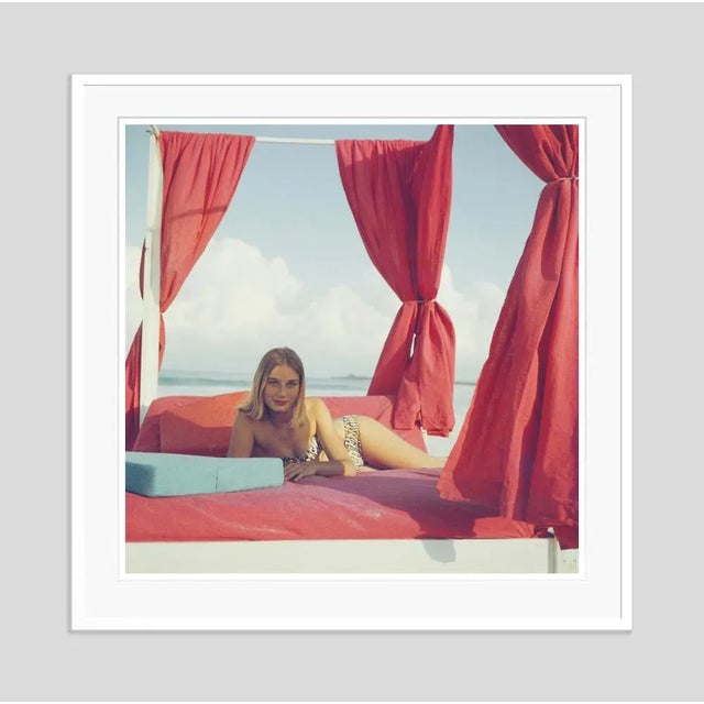 Tania Mallet' by Slim Aarons Open Edition 1961: Actress Tania Mallet relaxes on a red-curtained four poster in Eleuthera,...