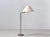 A timeless floor lamp with a restrained, elegant design and harmonious combination of materials. The slender brass-colored...