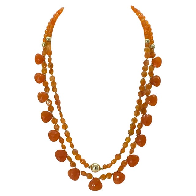 We created this orange tone carnelian stone necklace and high lighted heart briolette cut pendants. 6mm faceted coin...