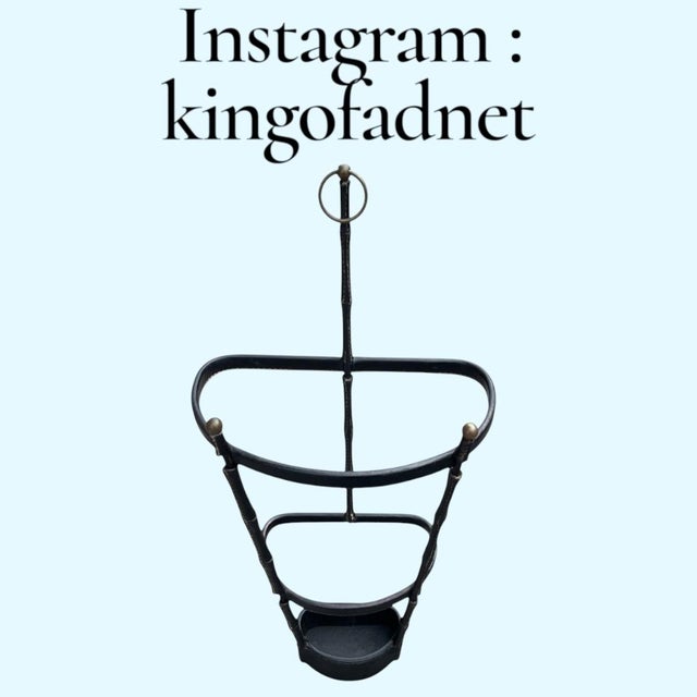 This umbrella stand exemplifies the iconic vocabulary of Jacques Adnet, characterized by the combination of metal and...