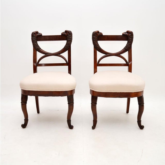 A fantastic pair of antique carved side chairs. They were made in continental Europe, possibly Denmark, or somewhere close...