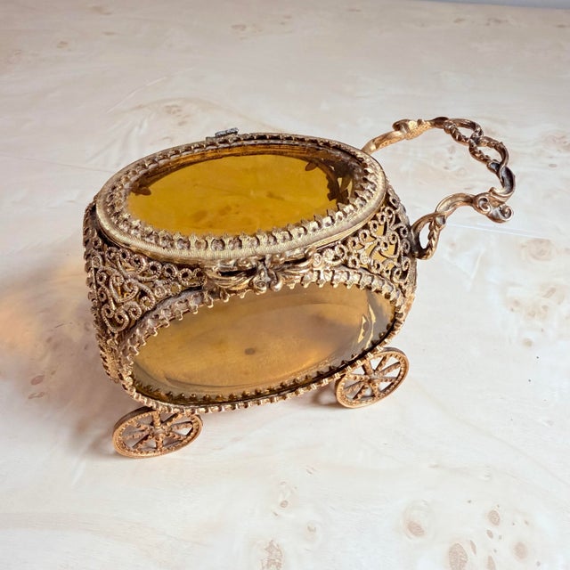 A charming antique jewelry casket in the form of a miniature carriage or pram, hand-finished in gilt brass with fine...