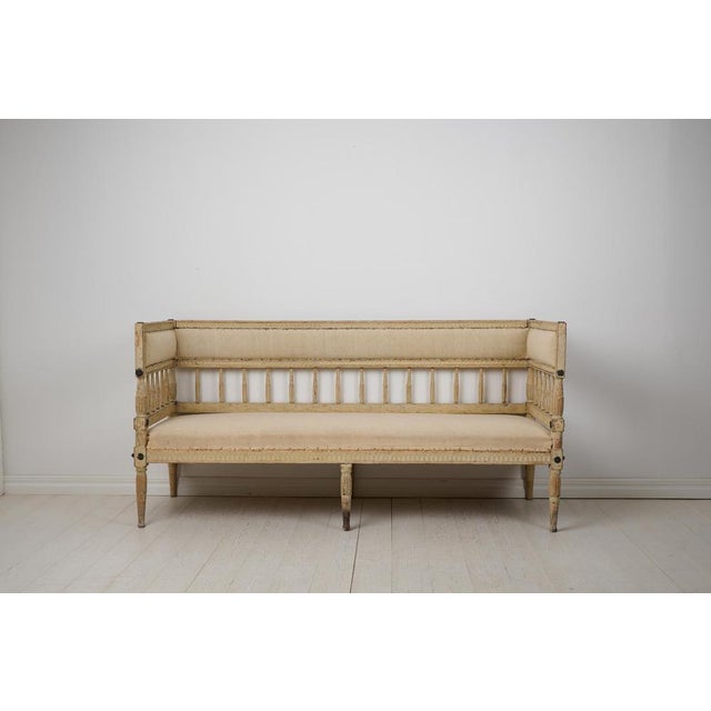 Swedish antique sofa from the gustavian period around the late 1700s. The sofa has a hand-made frame in solid pine which...