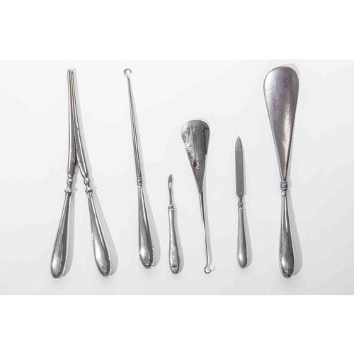 A refined and well-appointed gentleman’s grooming set comprising eight silver-plated vanity and dressing table implements,...