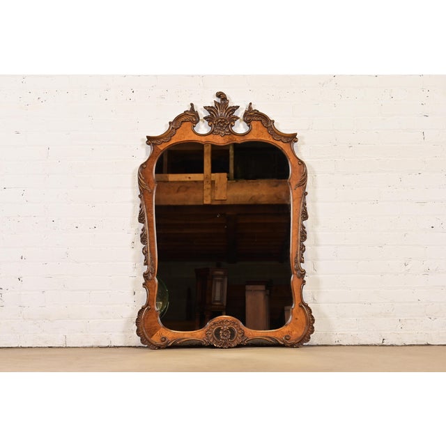 A beautiful antique French Rococo Louis XV or Baroque style carved burl wood framed wall mirror By Romweber USA, Circa...