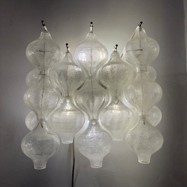 A pair of J.T. Kalmar 'Tulipan' wall sconces. Hanging rows of hand blown glass mounted on enameled harware containing five...