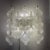 A pair of J.T. Kalmar 'Tulipan' wall sconces. Hanging rows of hand blown glass mounted on enameled harware containing five...