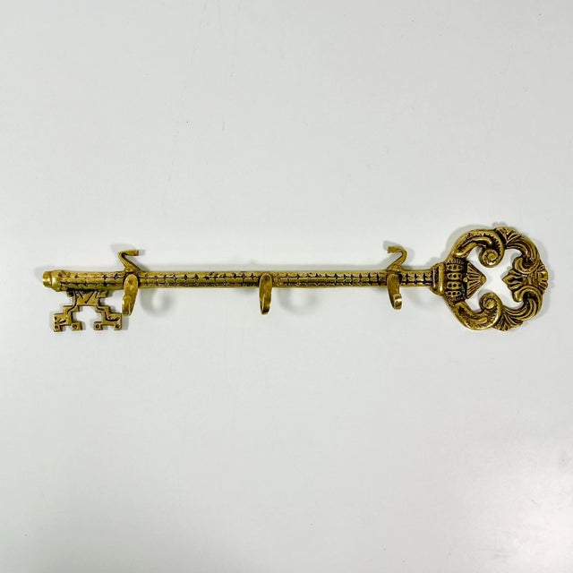 This is an English style antique Victorian Key Motif Wall Hook. The brass key has three hook pegs that are strong and...