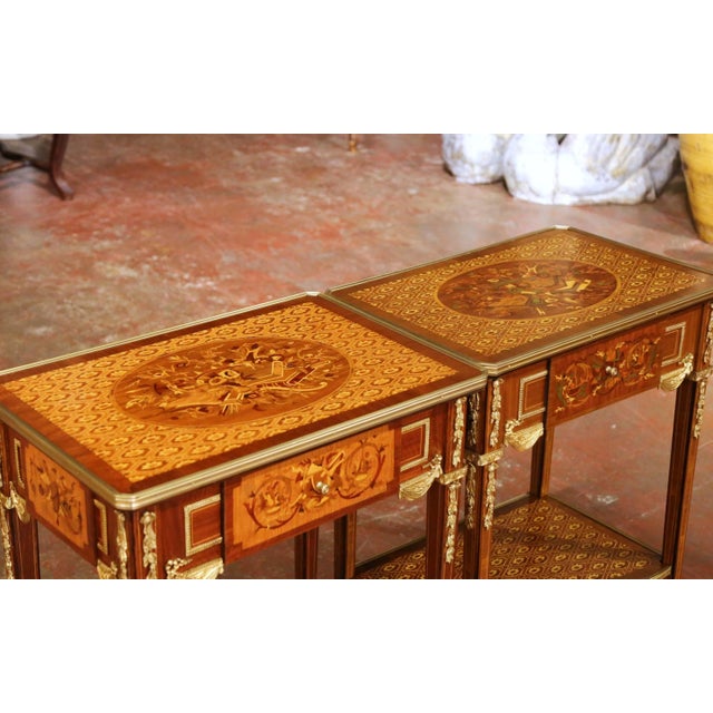 Decorate a living room, bedroom, or seating area with this elegant near pair of Mid-Century Louis XVI style side tables....