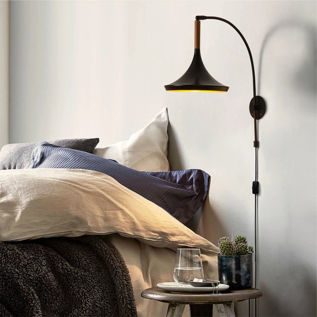 Elevate your space with the Lodi Wall Sconce, a stunning embodiment of mid-century flair and sophistication. The matte...