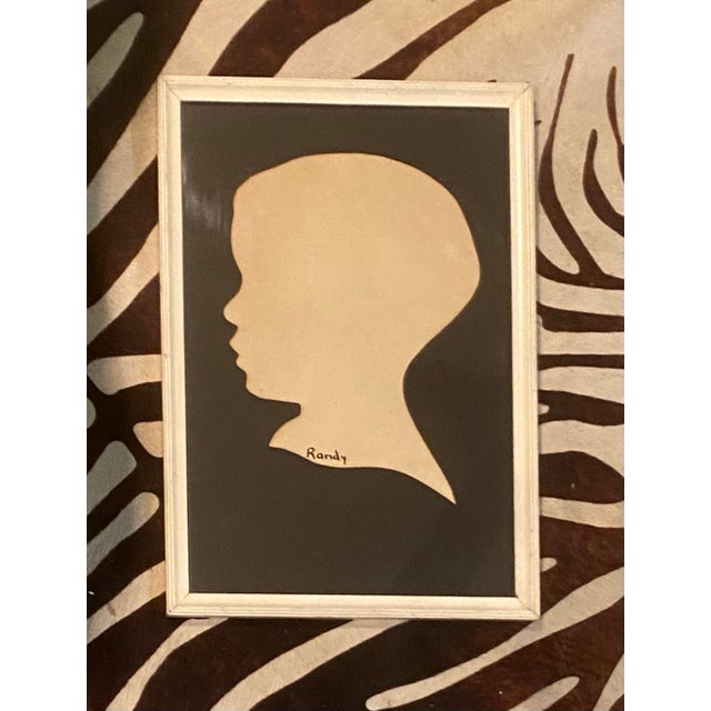 Charming vintage 1940s hand-cut paper silhouette portrait of a child labeled “Randy.” This sweet scissor-cut profile...