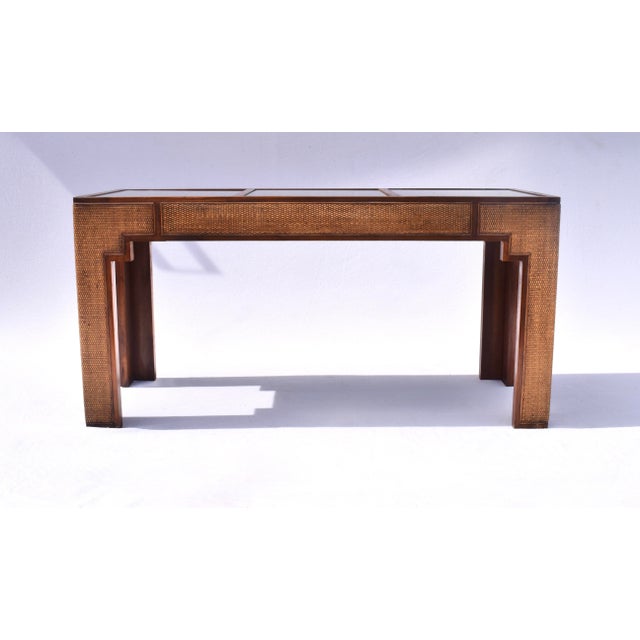 1970's walnut console table with wrapped grasscloth cane surround and three removable glass inserts. Striking Mughal-...