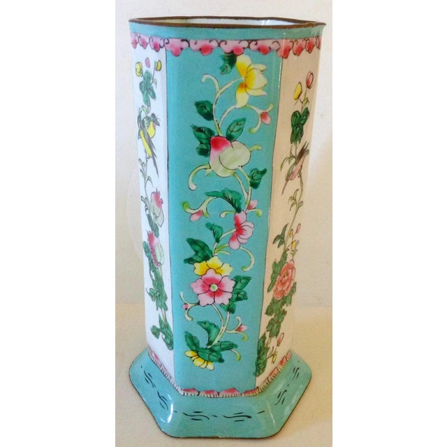 This 6 sided beautifully enameled vase has floral and bird motif surround. There is a small chip at the base shown in the...