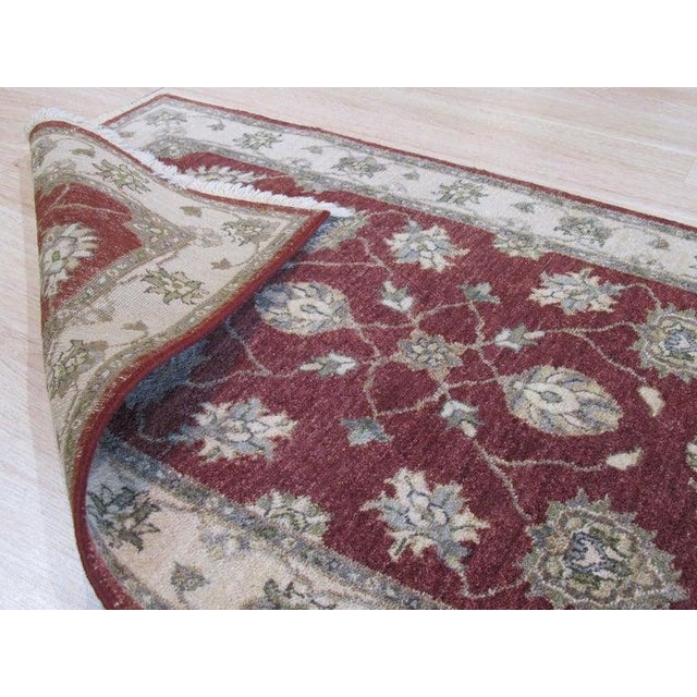 This hand knotted pile rug features a primary Red and Rust color palette crafted from durable wool. Designed in the style...