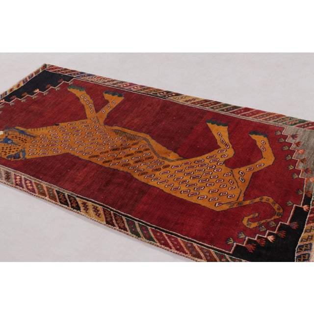 Hand-knotted in wool, this 3x6 vintage Gabbeh runner originates from Persia circa 1950-1960. This rug reflects the...