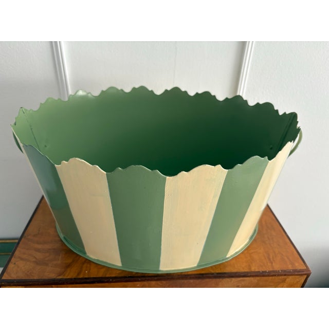 Vintage Two’s and Company scalloped urn with handles. The scalloped metal urn is hand painted with off white and green...