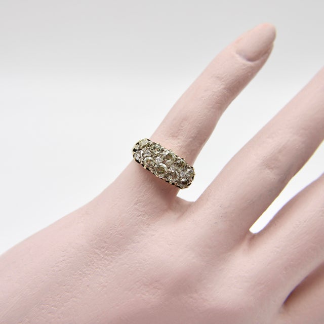 This spectacular Old Mine Cut diamond ring presents a wide band of encrusted diamond sparkle comprised of Old Mine Cut and...