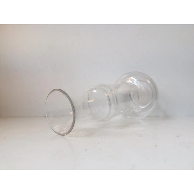 This large clear glass vase with a hooped body was designed by Björn Ramél and manufactured by SEA Glasbruk in Kosta,...